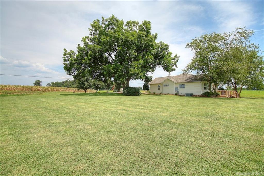 6114 Olive Branch Road Wingate, NC 28174 - Photo 8 of 24 a view of a field of grass and trees