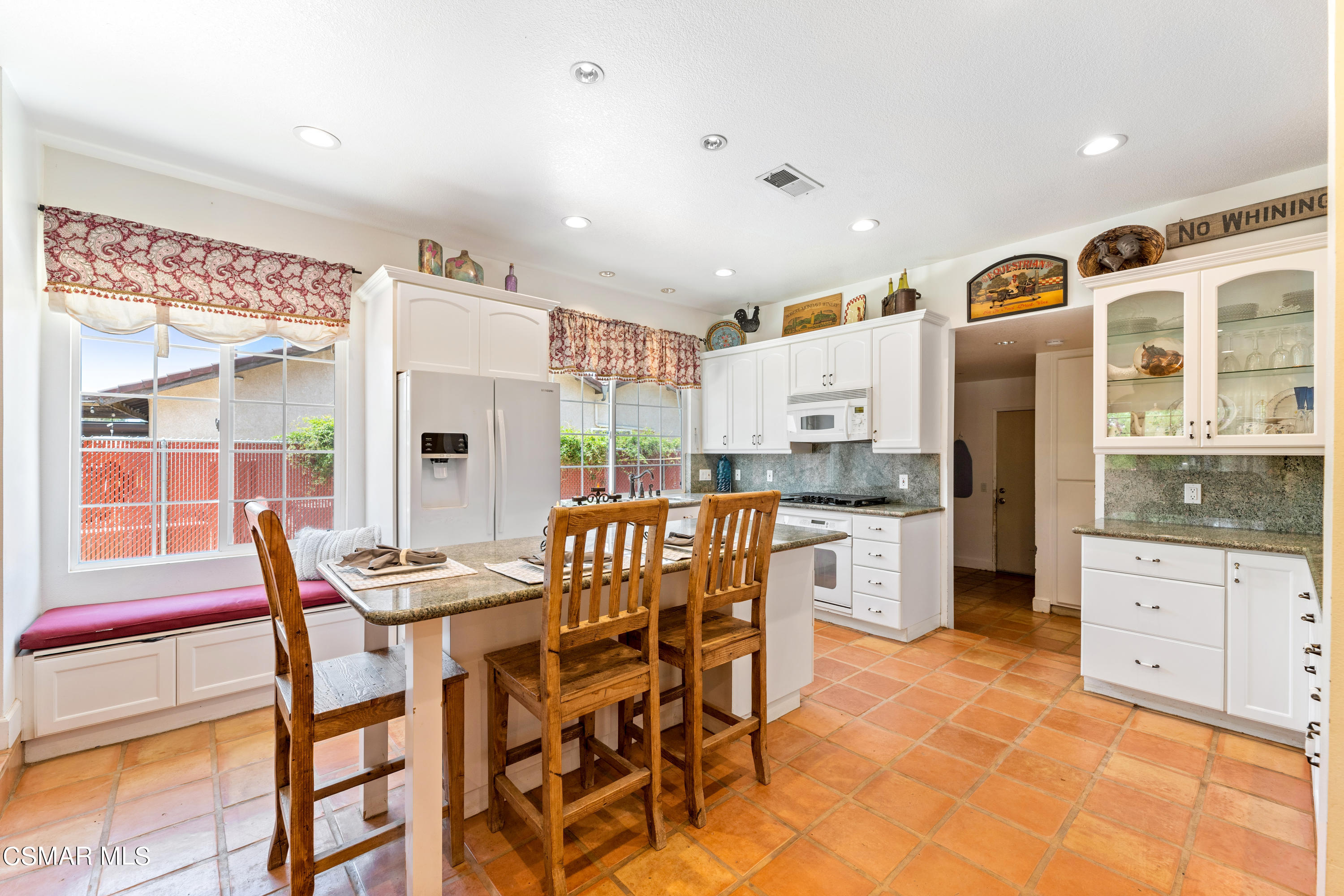 1704 Rambling Road Simi Valley, CA 93065 - Photo 4 of 40 a kitchen with stainless steel appliances kitchen island granite countertop a table and chairs in it