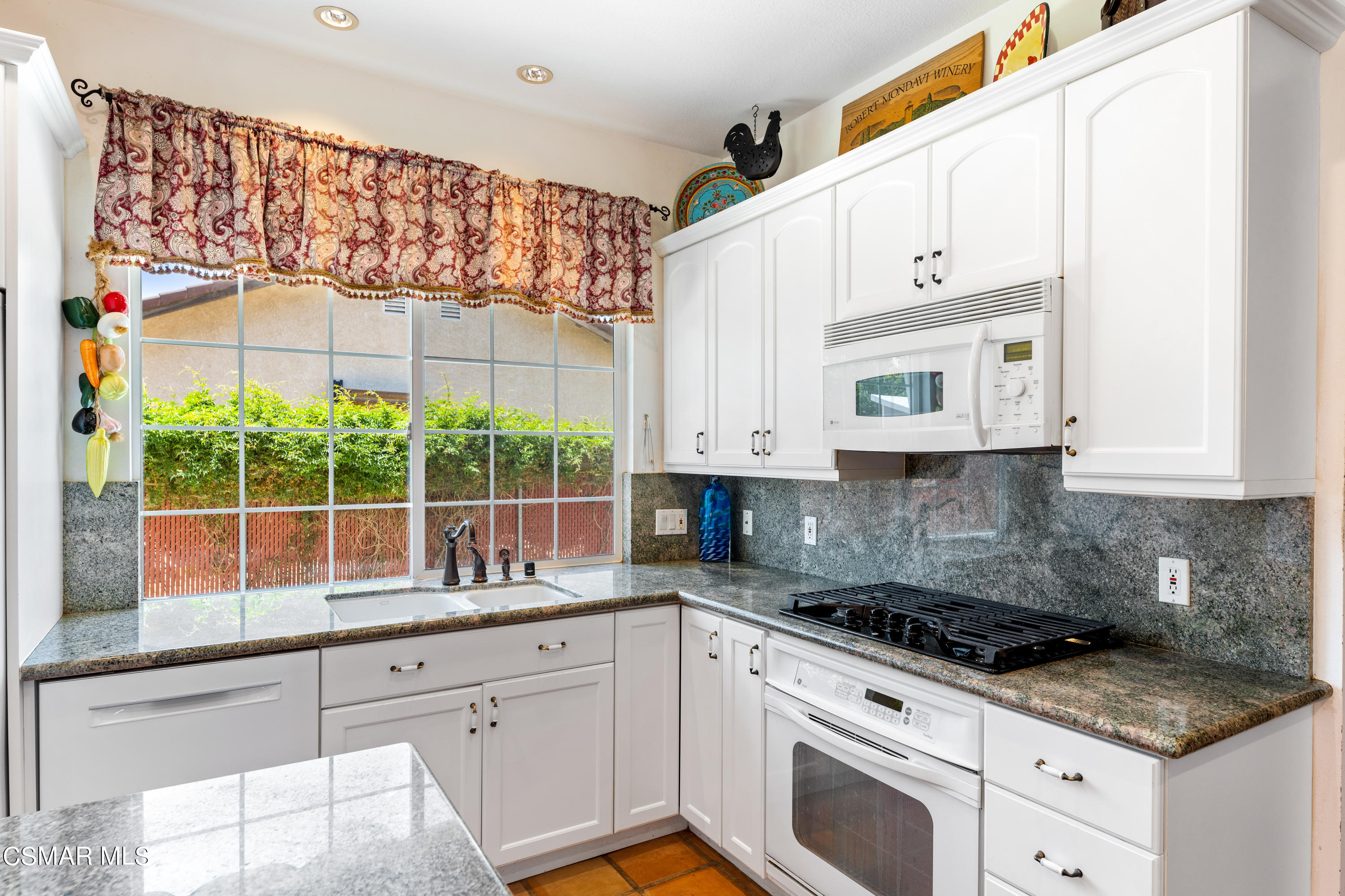 1704 Rambling Road Simi Valley, CA 93065 - Photo 5 of 40 a kitchen with stainless steel appliances granite countertop white cabinets granite counter tops and a window