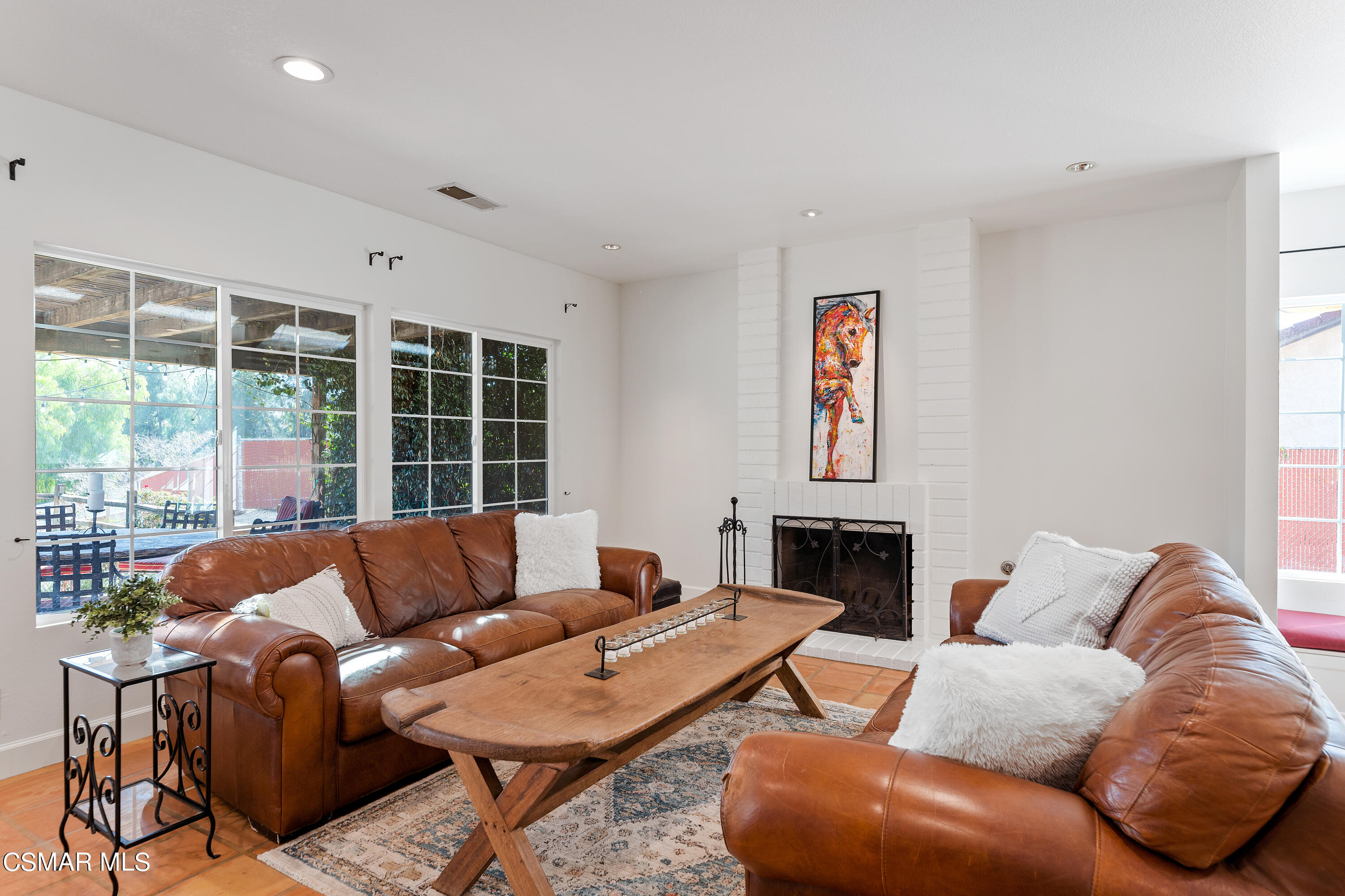 1704 Rambling Road Simi Valley, CA 93065 - Photo 7 of 40 a living room with furniture a large window and a fireplace
