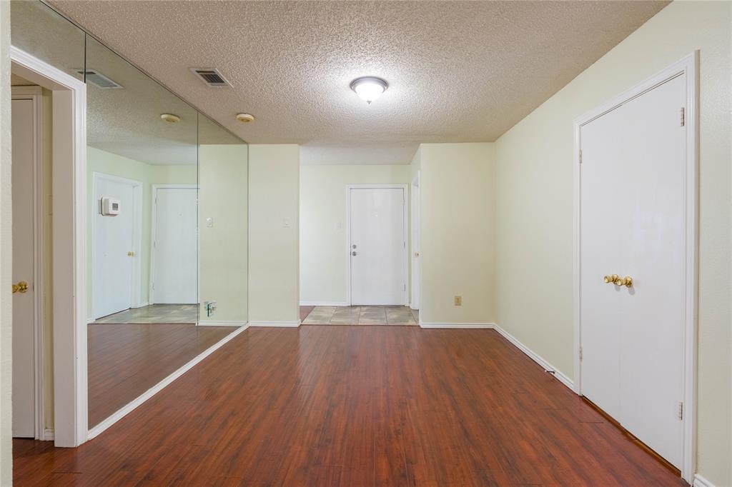5840 Spring Valley Road, Unit 212 Dallas, TX 75254 - Photo 13 of 32 a view of an empty room with wooden floor