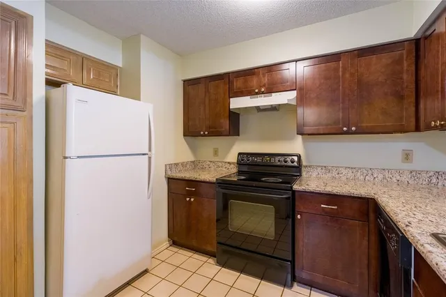 a kitchen with a stove and a refrigerator