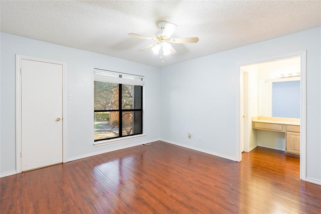 5840 Spring Valley Road, Unit 212 Dallas, TX 75254 - Photo 20 of 32 an empty room with wooden floor and windows