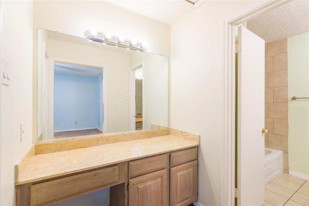 5840 Spring Valley Road, Unit 212 Dallas, TX 75254 - Photo 23 of 32 a bathroom with a sink and a mirror
