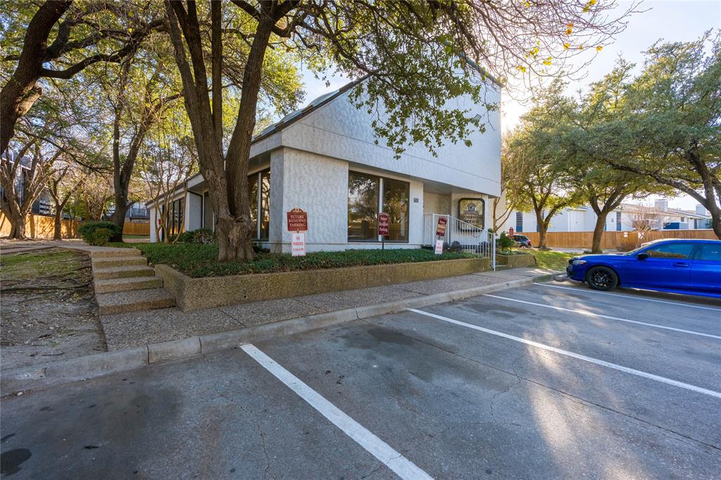 5840 Spring Valley Road, Unit 212 Dallas, TX 75254 - Photo 30 of 32 a front view of a house with a yard and garage