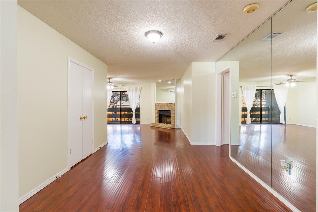 5840 Spring Valley Road, Unit 212 Dallas, TX 75254 - Photo 3 of 32 a view of a big room with wooden floor and a kitchen