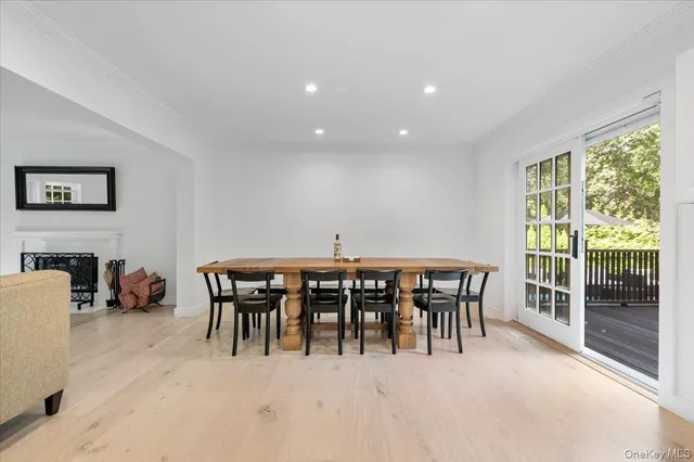 a view of a dining room with furniture and a floor to ceiling window
