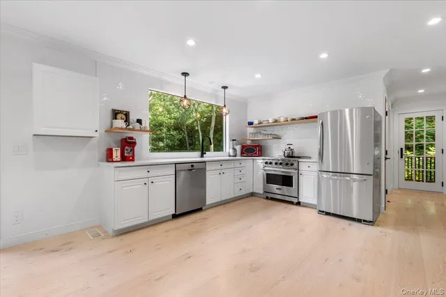 a kitchen with refrigerator cabinets and wooden floor