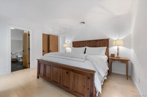 a bedroom with a bed and a lamp