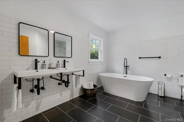 a spacious bathroom with a double vanity sink and a mirror