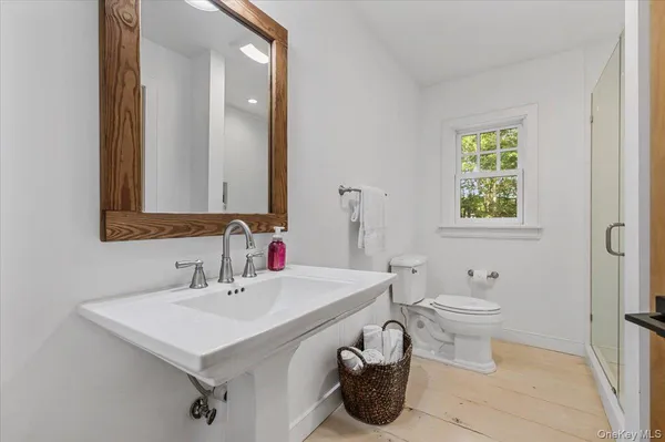 a bathroom with a sink toilet and mirror