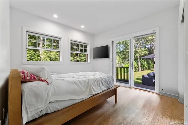 a bed sitting in a spacious bedroom next to a window