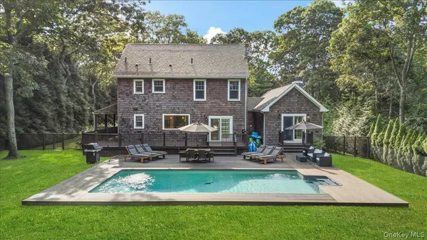 a front view of a house with a yard table and chairs