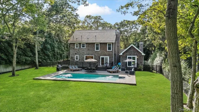 a view of a backyard with sitting area
