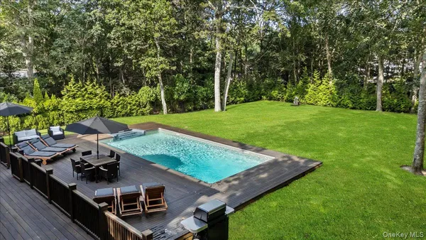 a view of backyard with deck and wooden floor