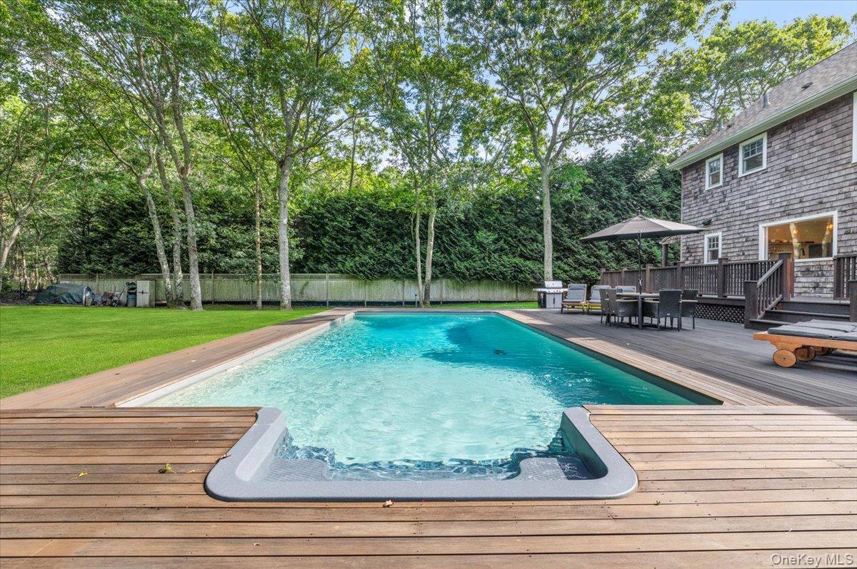 22 West Gate Road Wainscott, NY 11975 - Photo 38 of 42 a view of a swimming pool with a patio