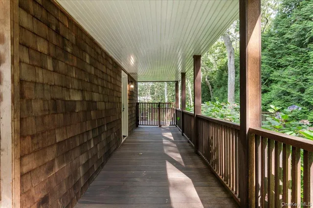 a view of a balcony with wooden floor