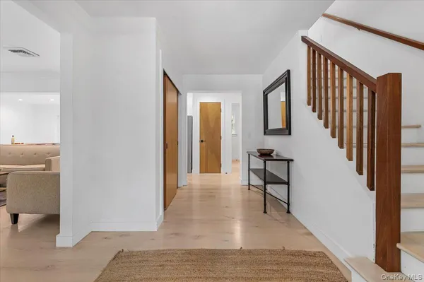a view of a hallway with furniture and entryway