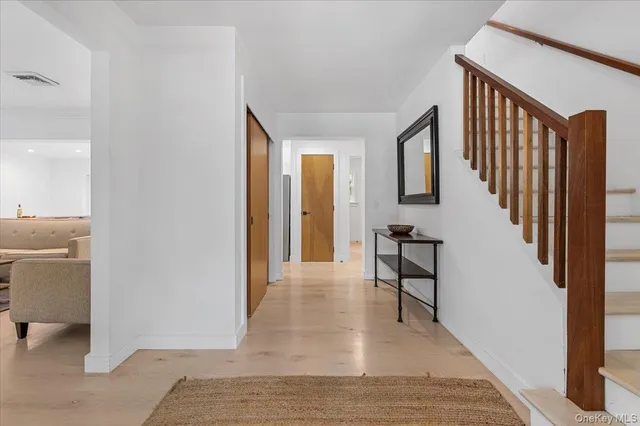 a view of a hallway with furniture and entryway