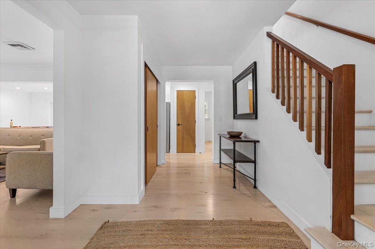 22 West Gate Road Wainscott, NY 11975 - Photo 7 of 42 a view of a hallway with furniture and entryway