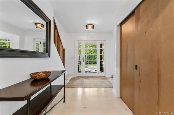 a view of a hallway with wooden floor and furniture