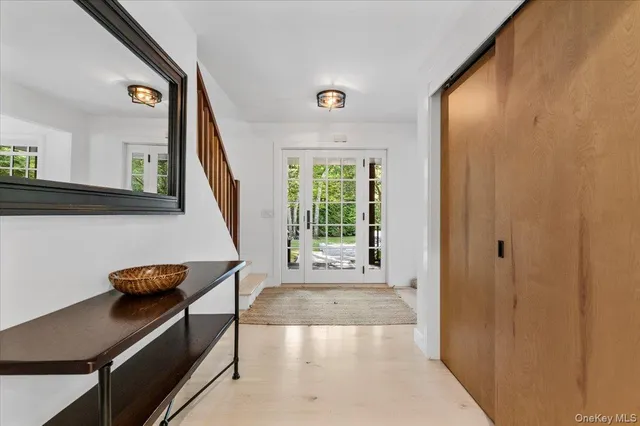 a view of a hallway with wooden floor and furniture