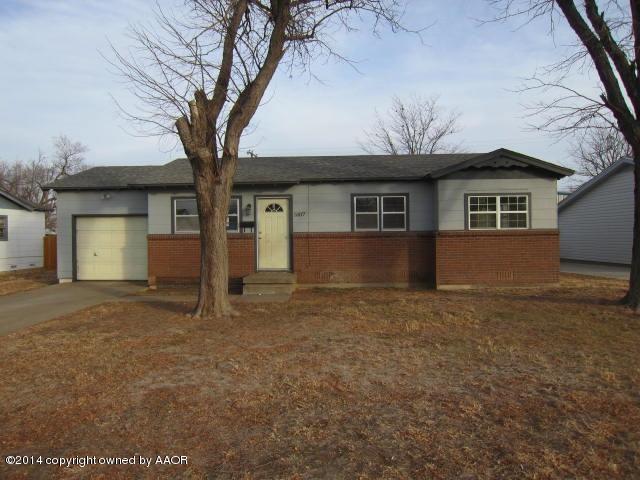 5107 Crockett Street Amarillo, TX 79110 - Photo 1 of 12 a house that has a tree in front of it