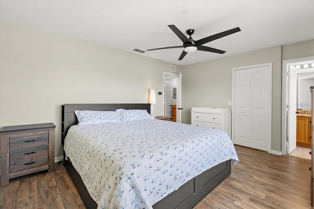 122 Capri Drive Davenport, FL 33897 - Photo 17 of 35 a bedroom with a bed and a ceiling fan