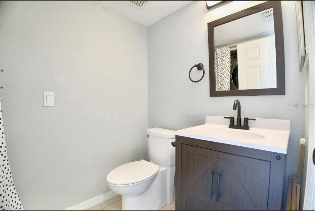 122 Capri Drive Davenport, FL 33897 - Photo 26 of 35 a bathroom with a toilet sink and mirror