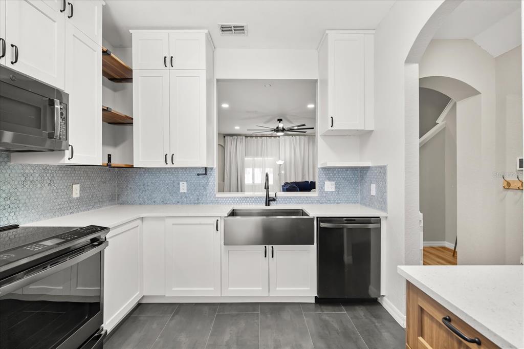 122 Capri Drive Davenport, FL 33897 - Photo 3 of 35 a kitchen with a sink stove and cabinets
