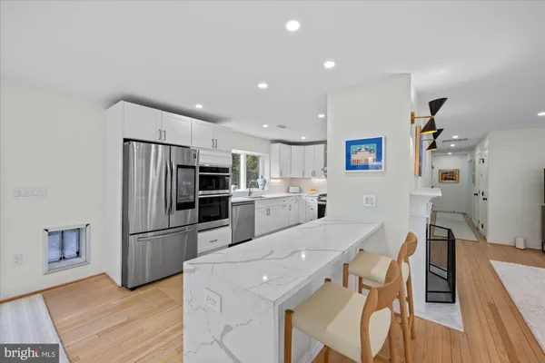 a kitchen with stainless steel appliances a refrigerator and a stove top oven