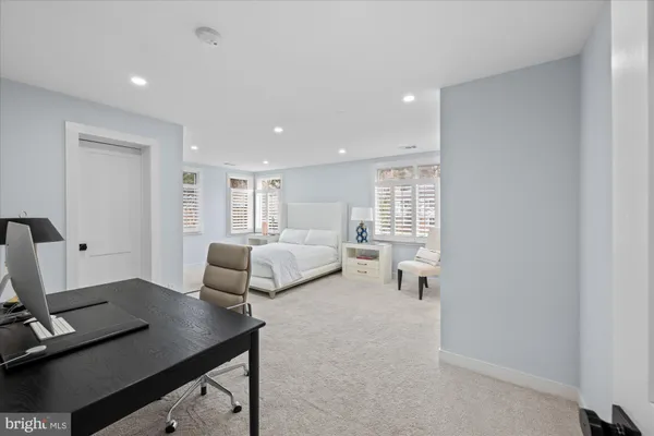 a bedroom with a bed and a desk