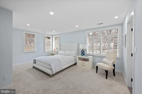 a spacious bedroom with a bed and a couch