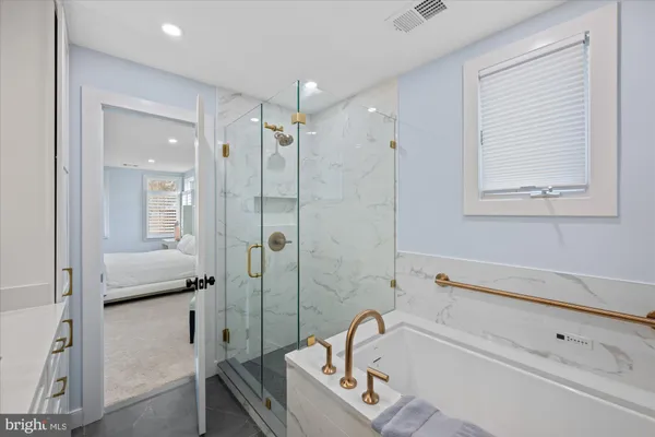 a bathroom with a tub shower and sink
