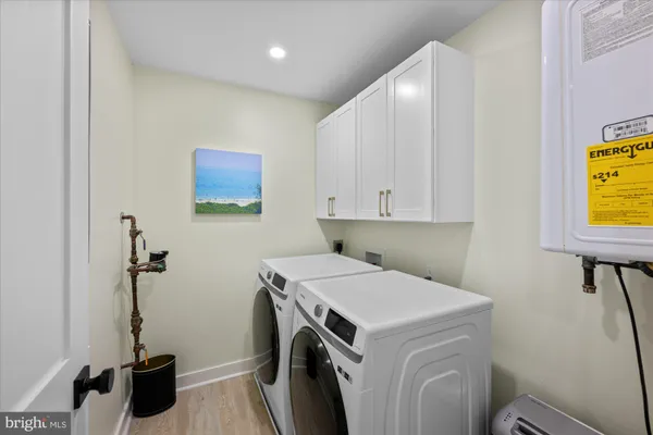 a view of a storage & utility room with a washer dryer