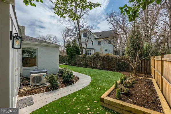 a view of a backyard with plants and a garden