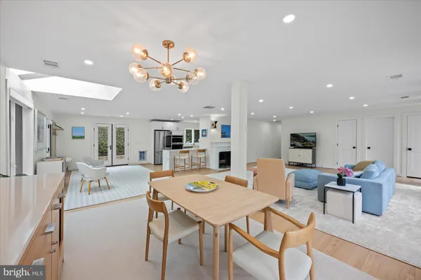 a view of a dining room with furniture and a kitchen