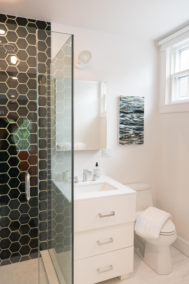 59 Orange Street Nantucket, MA 02554 - Photo 24 of 42 a bathroom with a sink toilet vanity and shower