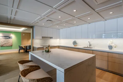 a kitchen with a table chairs sink and cabinets