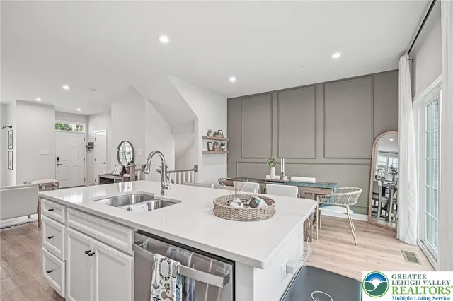 a kitchen with kitchen island a sink table and chairs