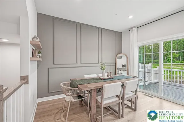 a dining room with furniture and wooden floor