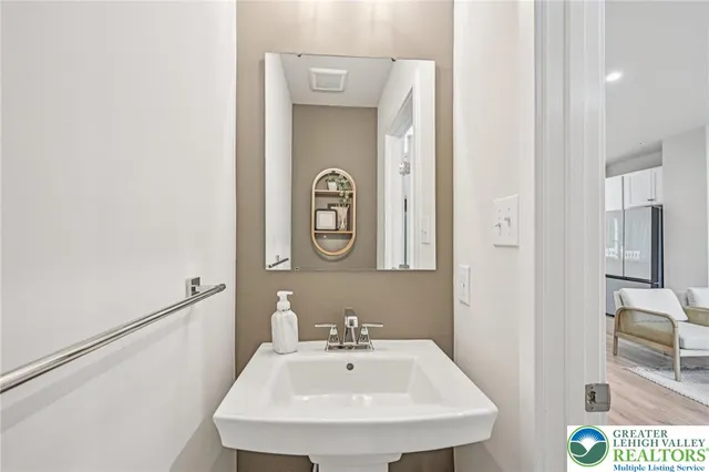 a bathroom with a sink a mirror and a window