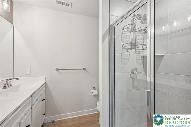a bathroom with a shower and a sink