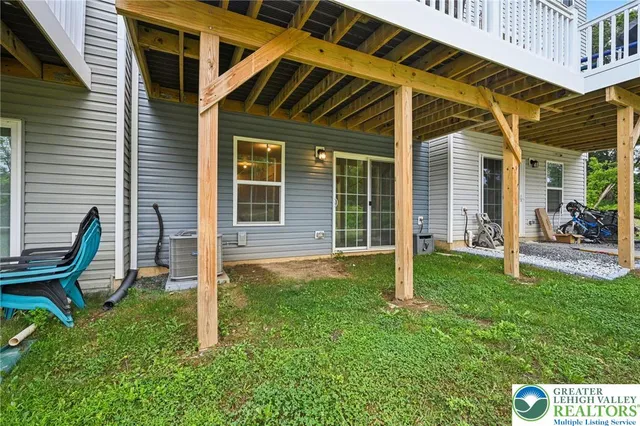 a backyard of a house with table and chairs