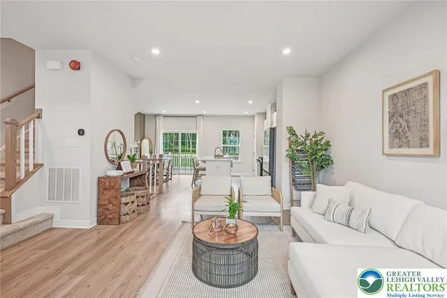 a living room with furniture potted plant and a window