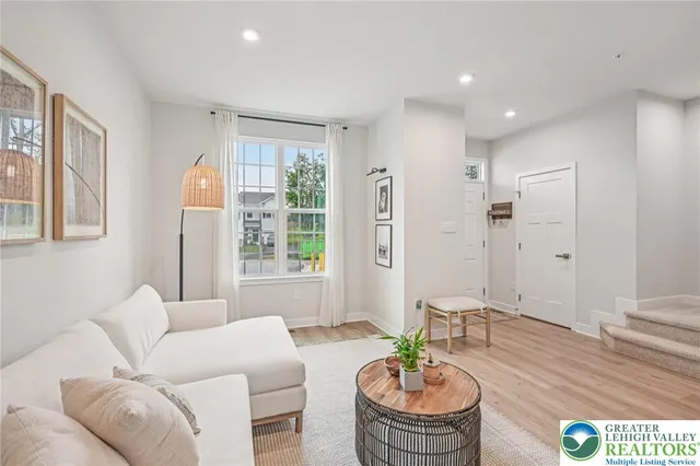 a living room with furniture and a large window