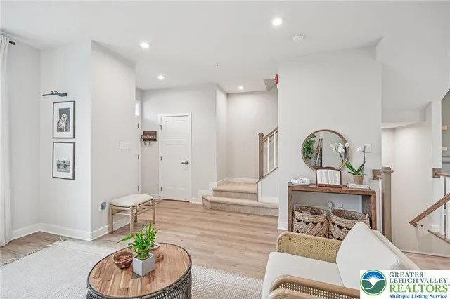 a living room with furniture flowerpot and a rug