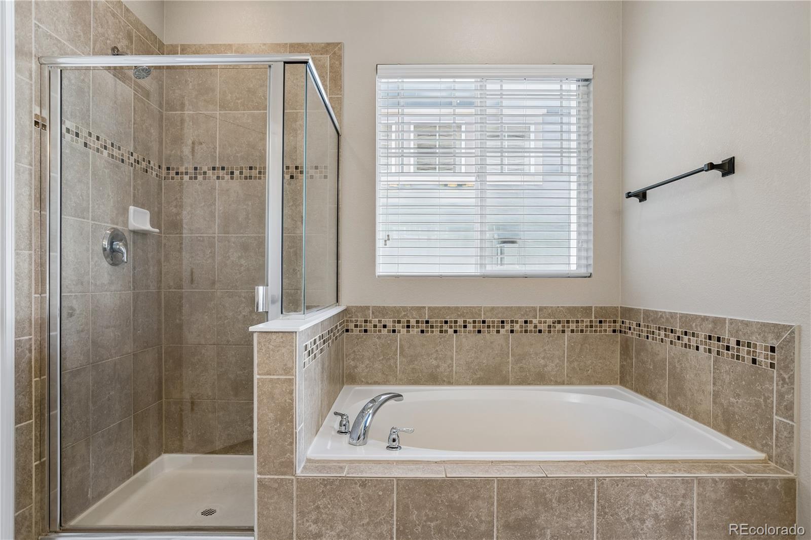 5031 South Rome Street Aurora, CO 80015 - Photo 19 of 39 a bathroom with a bath tub and a shower