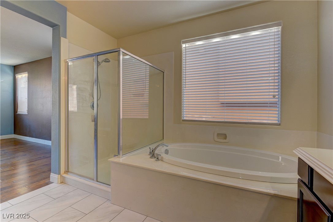 972 Rue Grand Paradis Lane Henderson, NV 89011 - Photo 17 of 32 Full bath with a shower stall, a garden tub, vanity, and plenty of natural light