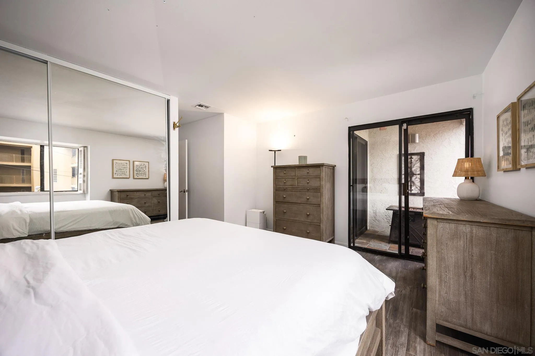 3568 Front Street, Unit D San Diego, CA 92103 - Photo 12 of 24 a bedroom with a large bed and wooden floor